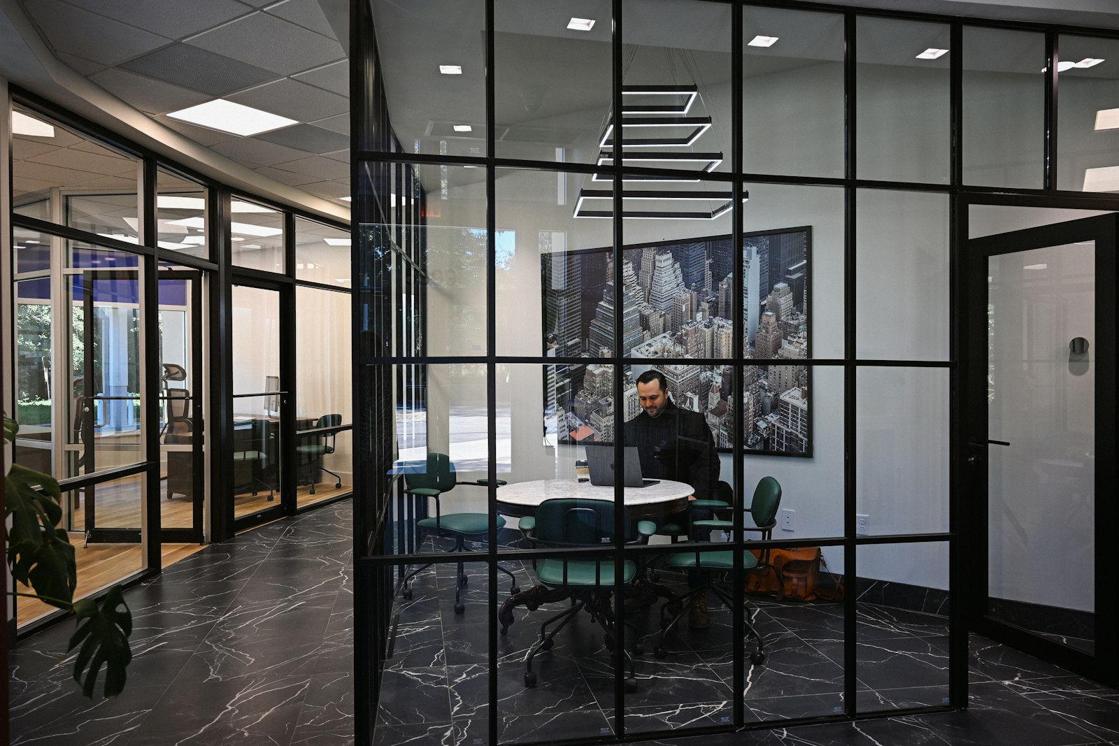 Business professional working from a laptop in a modern meeting room